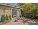 Inviting backyard featuring a brick patio, fire pit, outdoor seating, and access to the home through French doors at 640 N Osprey Ave, Sarasota, FL 34236