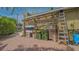 Backyard with equipment storage, boats, ladders, and green trash bins at 640 N Osprey Ave, Sarasota, FL 34236