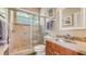 This bathroom offers a glass shower with a tile surround and a granite countertop sink with a wood cabinet at 640 N Osprey Ave, Sarasota, FL 34236