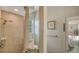 Bathroom featuring a glass shower, sandy tile walls, and neutral color palette at 640 N Osprey Ave, Sarasota, FL 34236