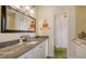 Stylish bathroom with a granite countertop and a view of the closet through the doorway at 640 N Osprey Ave, Sarasota, FL 34236