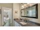 Bathroom vanity with a stone counter top and a large mirror reflecting the outdoor living space at 640 N Osprey Ave, Sarasota, FL 34236