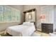 This bedroom offers a bed with white linens, shuttered windows and a dark dresser at 640 N Osprey Ave, Sarasota, FL 34236