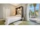 Bright bedroom featuring a Murphy bed, with direct access to an outdoor patio through elegant French doors at 640 N Osprey Ave, Sarasota, FL 34236