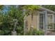 Exterior close up of a stucco home with a sculpture and greenery at 640 N Osprey Ave, Sarasota, FL 34236