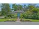 Charming home with blue door, brick path, and lush landscaping at 640 N Osprey Ave, Sarasota, FL 34236