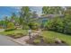 Quaint home featuring a blue door, lush greenery, and a brick pathway at 640 N Osprey Ave, Sarasota, FL 34236