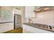 Kitchen with stainless appliances, gas range, white cabinets, and bar seating at 640 N Osprey Ave, Sarasota, FL 34236