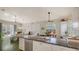 Open-concept kitchen with a large island, stainless steel appliances, and views of the living room at 640 N Osprey Ave, Sarasota, FL 34236