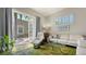 Bright living room featuring an open patio, white leather sofas, and shuttered windows at 640 N Osprey Ave, Sarasota, FL 34236
