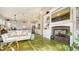 Spacious open floor plan with fireplace, a white sofa, and an open flow into the kitchen at 640 N Osprey Ave, Sarasota, FL 34236