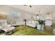 The bright living room features a view of the open kitchen, two couches and green concrete floor at 640 N Osprey Ave, Sarasota, FL 34236