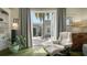 Cozy living room with a view of the exterior patio through open glass doors and white leather chair at 640 N Osprey Ave, Sarasota, FL 34236
