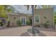 Inviting outdoor brick patio area with a cozy dining set and lush tropical landscaping, ideal for entertaining or relaxation at 640 N Osprey Ave, Sarasota, FL 34236