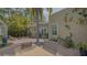 Charming outdoor brick patio featuring a dining set, lush landscaping, and decorative accents for relaxed outdoor living at 640 N Osprey Ave, Sarasota, FL 34236