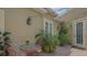 Charming outdoor brick patio with decorative lighting and lush tropical landscaping, perfect for alfresco dining and relaxation at 640 N Osprey Ave, Sarasota, FL 34236