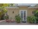 Inviting outdoor brick patio featuring French doors and lush landscaping, creating a serene and private outdoor living space at 640 N Osprey Ave, Sarasota, FL 34236