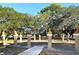 Outdoor park featuring stone art busts displayed on stone pillars surrounded by trees on a sunny day with blue skies at 640 N Osprey Ave, Sarasota, FL 34236