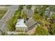 Aerial view of a home's rear exterior with lush landscaping and a spacious brick patio, perfect for outdoor entertaining at 640 N Osprey Ave, Sarasota, FL 34236