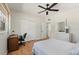 Bright bedroom with a ceiling fan, a built-in desk, and a large mirror over the dresser at 6715 Georgia Ave, Bradenton, FL 34207