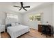 This bedroom features a window view, wood floors, and a ceiling fan at 6715 Georgia Ave, Bradenton, FL 34207