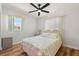 Cozy bedroom with a ceiling fan and a window with blinds, providing natural light at 6715 Georgia Ave, Bradenton, FL 34207