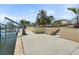 Waterfront dock featuring a boat lift and concrete dock with landscaping at 6715 Georgia Ave, Bradenton, FL 34207