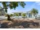 Charming home exterior with beautifully landscaped front yard, lush greenery, and well-manicured lawn at 6715 Georgia Ave, Bradenton, FL 34207