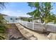 Charming home with well-maintained landscaping and a white picket fence leading to the entrance at 6715 Georgia Ave, Bradenton, FL 34207