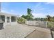 Spacious patio with a grill, white picket fence, and serene waterfront views at 6715 Georgia Ave, Bradenton, FL 34207
