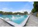 Community pool with ample space for swimming and recreation under a clear blue sky at 6715 Georgia Ave, Bradenton, FL 34207