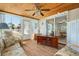 Cozy sunroom featuring a wood-paneled ceiling, large windows, and comfortable seating at 6715 Georgia Ave, Bradenton, FL 34207