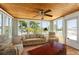 Comfortable sunroom with a wood-paneled ceiling, comfortable seating, and serene water views at 6715 Georgia Ave, Bradenton, FL 34207