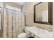 Well-lit bathroom featuring a patterned shower curtain, toilet, and a large mirror over the sink at 7253 Orchid Island Pl, Bradenton, FL 34202