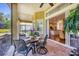 Enjoy outdoor dining on this screened patio with brick pavers and views of the interior and backyard at 7253 Orchid Island Pl, Bradenton, FL 34202