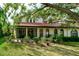 Exterior view of a home with a tiled roof and a well-maintained backyard at 7340 Villa D Este Drive, Sarasota, FL 34238