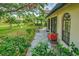 Charming backyard patio with lush landscaping and tropical palms at 7340 Villa D Este Drive, Sarasota, FL 34238