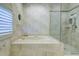 A tiled bathtub and walk in shower in a primary bathroom at 7340 Villa D Este Drive, Sarasota, FL 34238