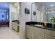Dual vanities, dark countertops, and walk-in shower in this bathroom at 7340 Villa D Este Drive, Sarasota, FL 34238