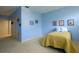 Bedroom in light blue color with yellow and blue comforter at 7340 Villa D Este Drive, Sarasota, FL 34238