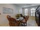 Bright dining room with modern light fixtures, hardwood floors and an abundance of windows at 7340 Villa D Este Drive, Sarasota, FL 34238