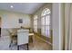 Cozy dining room featuring a glass table, four chairs, and arched windows with shutters at 7340 Villa D Este Drive, Sarasota, FL 34238