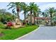 Community entrance sign with manicured landscaping and a guardhouse, ensuring privacy and security at 7340 Villa D Este Drive, Sarasota, FL 34238