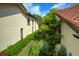 Exterior view of well-maintained homes with manicured lawns and lush greenery, showcasing the property's appeal at 7340 Villa D Este Drive, Sarasota, FL 34238