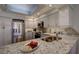 Modern kitchen featuring stainless steel appliances, granite countertops, and ample cabinet space at 7340 Villa D Este Drive, Sarasota, FL 34238