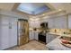 Bright kitchen with gray cabinets, stainless steel appliances, and granite countertops at 7340 Villa D Este Drive, Sarasota, FL 34238