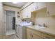 Functional laundry room with ample storage and countertop space at 7340 Villa D Este Drive, Sarasota, FL 34238