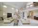 Spacious living room with high ceilings, lots of light, two sofas, and a staircase at 7340 Villa D Este Drive, Sarasota, FL 34238