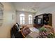 Cozy living room features a ceiling fan, large windows, hardwood floors, and a built-in entertainment center at 7340 Villa D Este Drive, Sarasota, FL 34238