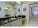 Bright main bathroom features double sinks, granite counters, designer tile and an abundance of storage at 7340 Villa D Este Drive, Sarasota, FL 34238